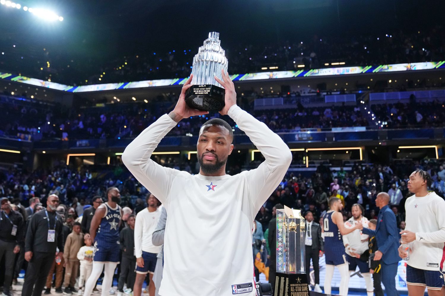 Damian Lillard holds up the MVP trophy after the NBA All-Star Game.